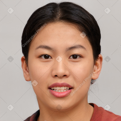 Joyful asian young-adult female with short  brown hair and brown eyes