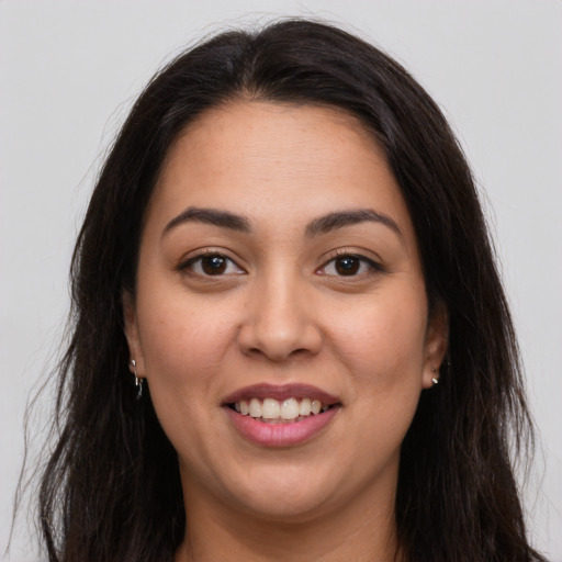Joyful latino young-adult female with long  brown hair and brown eyes