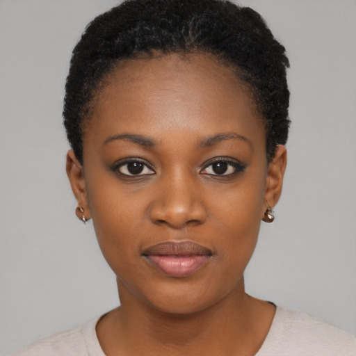 Joyful black young-adult female with short  black hair and brown eyes