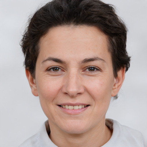 Joyful white adult female with short  brown hair and brown eyes