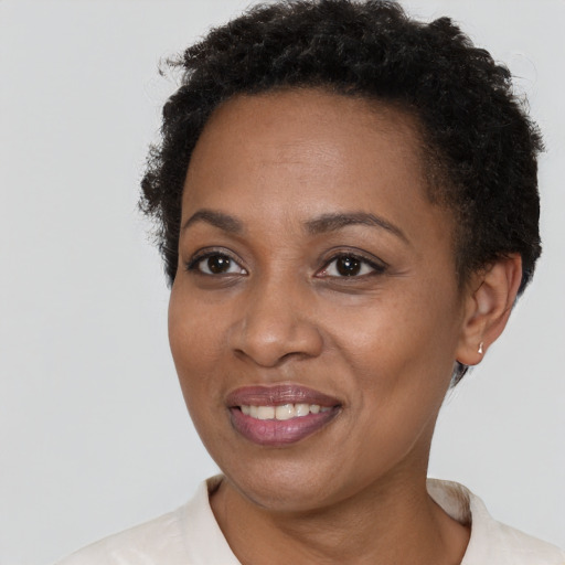 Joyful black young-adult female with short  brown hair and brown eyes