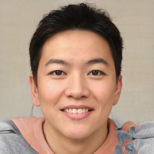Joyful asian young-adult male with short  brown hair and brown eyes