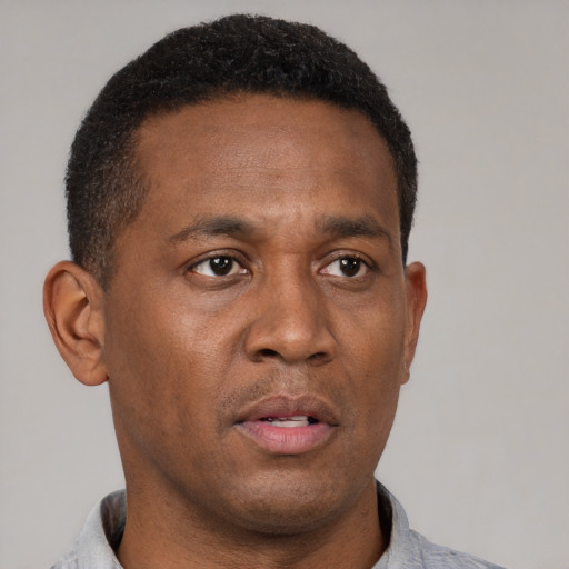 Neutral black adult male with short  black hair and brown eyes
