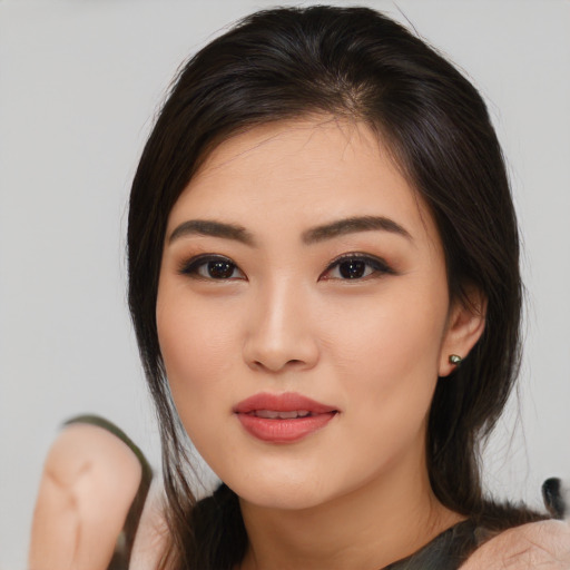 Joyful asian young-adult female with medium  brown hair and brown eyes