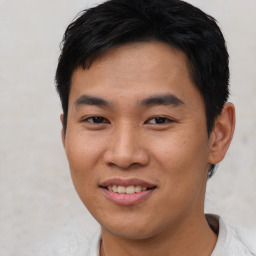 Joyful asian young-adult male with short  brown hair and brown eyes