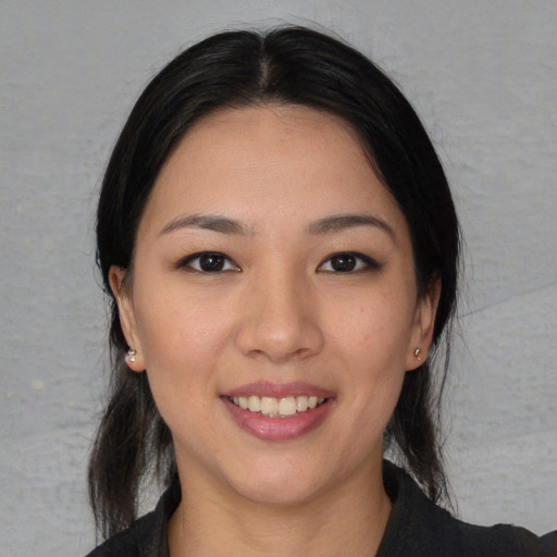 Joyful asian young-adult female with long  black hair and brown eyes