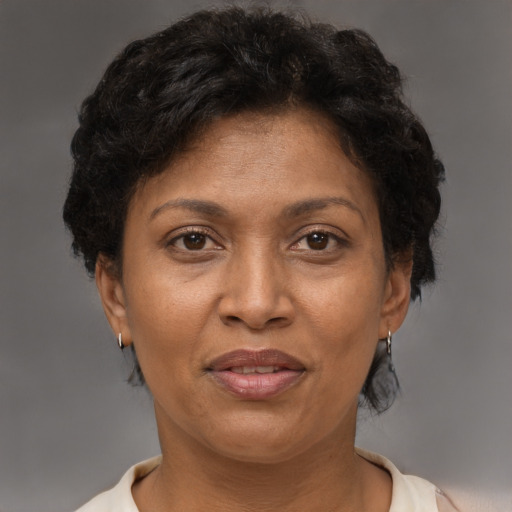 Joyful latino adult female with short  brown hair and brown eyes