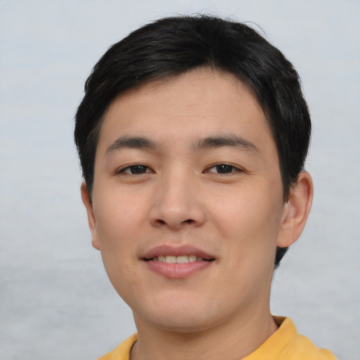 Joyful asian young-adult male with short  brown hair and brown eyes