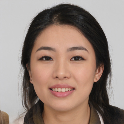 Joyful asian young-adult female with medium  black hair and brown eyes