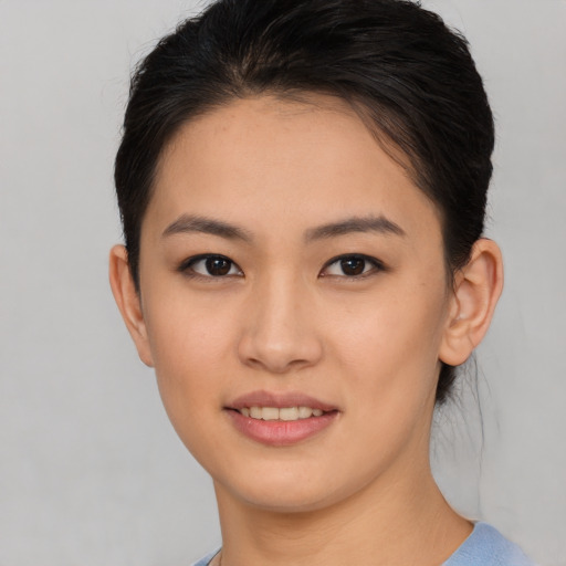 Joyful asian young-adult female with short  brown hair and brown eyes