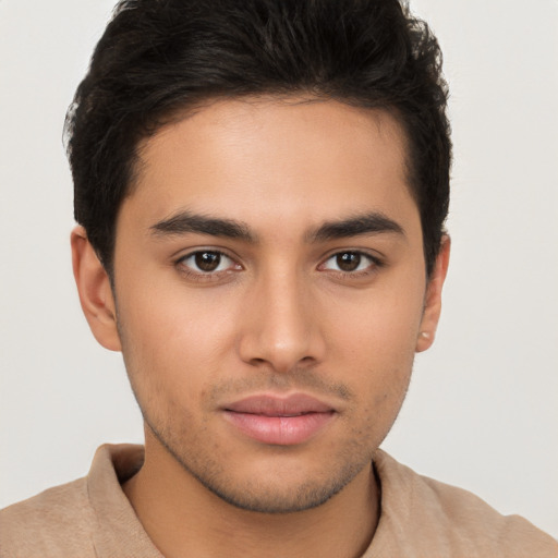 Joyful latino young-adult male with short  brown hair and brown eyes