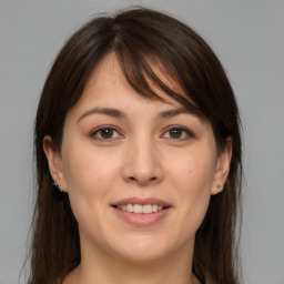 Joyful white young-adult female with medium  brown hair and brown eyes