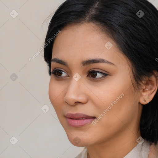 Joyful latino young-adult female with medium  black hair and brown eyes