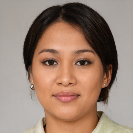 Joyful latino young-adult female with medium  brown hair and brown eyes