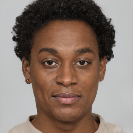 Joyful black adult male with short  brown hair and brown eyes