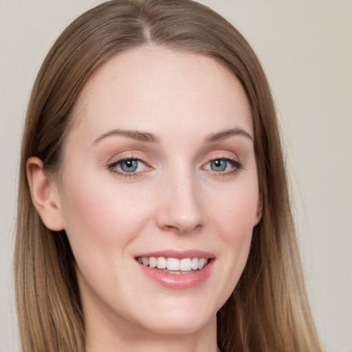 Joyful white young-adult female with long  brown hair and grey eyes