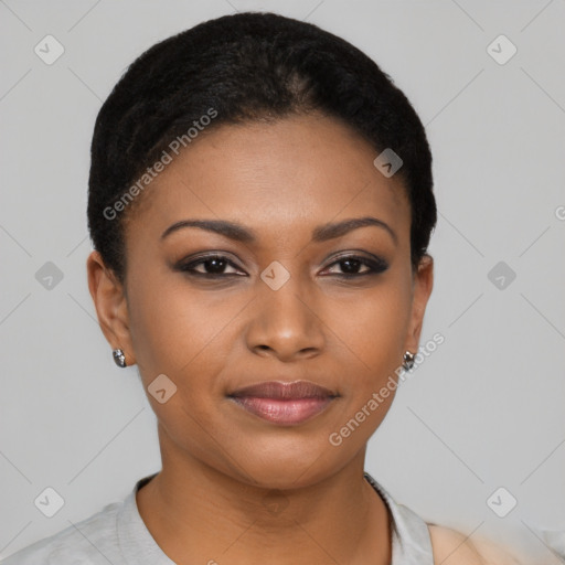 Joyful black young-adult female with short  black hair and brown eyes