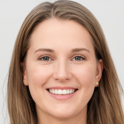 Joyful white young-adult female with long  brown hair and grey eyes