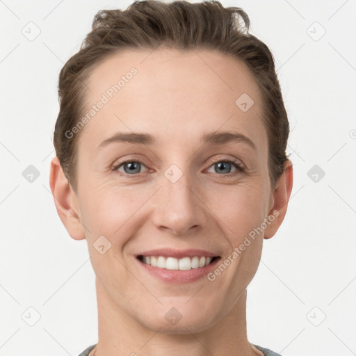 Joyful white young-adult female with short  brown hair and grey eyes