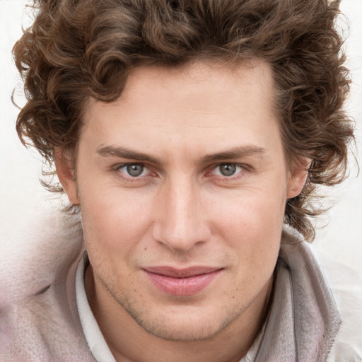 Joyful white young-adult male with short  brown hair and blue eyes