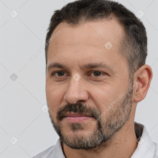 Joyful white adult male with short  brown hair and brown eyes