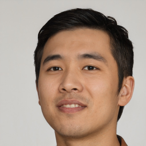 Joyful asian young-adult male with short  black hair and brown eyes