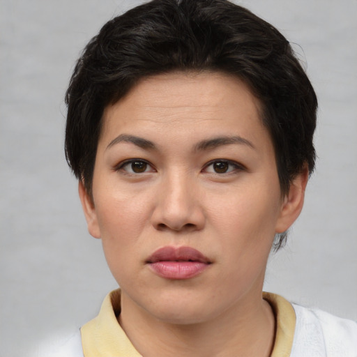 Joyful asian young-adult female with short  brown hair and brown eyes