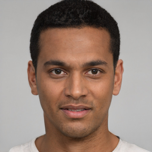 Joyful latino young-adult male with short  black hair and brown eyes