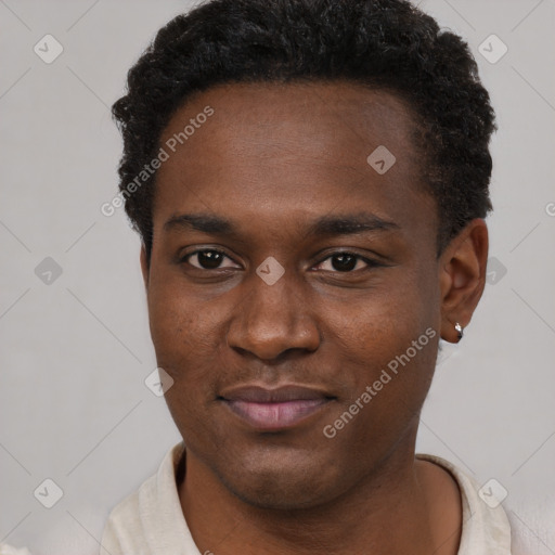 Joyful black young-adult male with short  brown hair and brown eyes