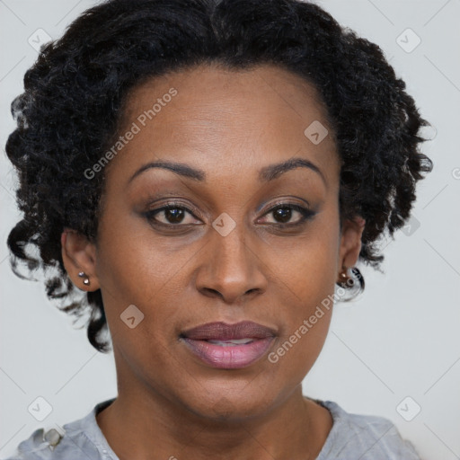 Joyful black adult female with short  brown hair and brown eyes