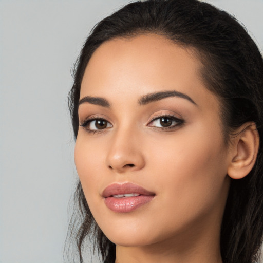 Joyful latino young-adult female with long  black hair and brown eyes