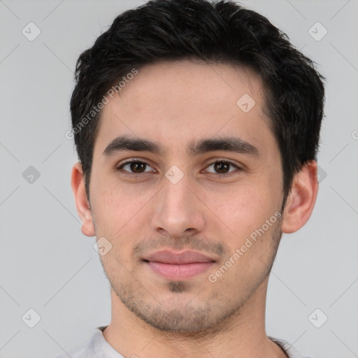 Joyful white young-adult male with short  black hair and brown eyes