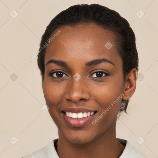 Joyful black young-adult female with short  black hair and brown eyes