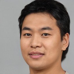 Joyful asian young-adult male with short  black hair and brown eyes