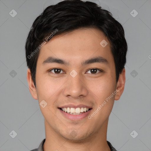 Joyful asian young-adult male with short  brown hair and brown eyes