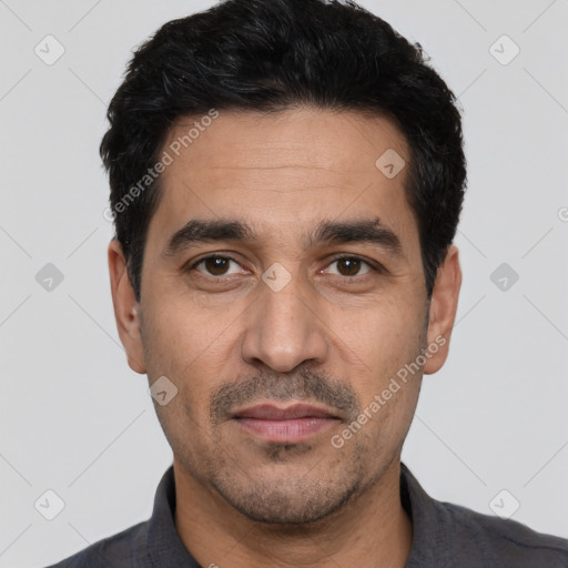 Joyful white adult male with short  black hair and brown eyes
