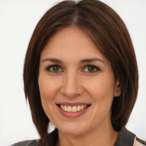 Joyful white adult female with medium  brown hair and brown eyes