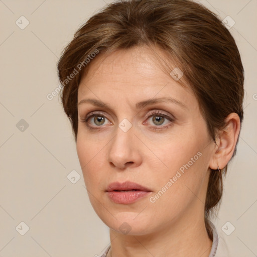 Joyful white adult female with medium  brown hair and grey eyes