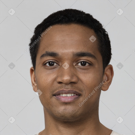 Joyful black young-adult male with short  black hair and brown eyes