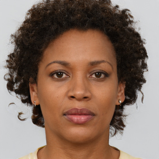 Neutral black young-adult female with medium  brown hair and brown eyes