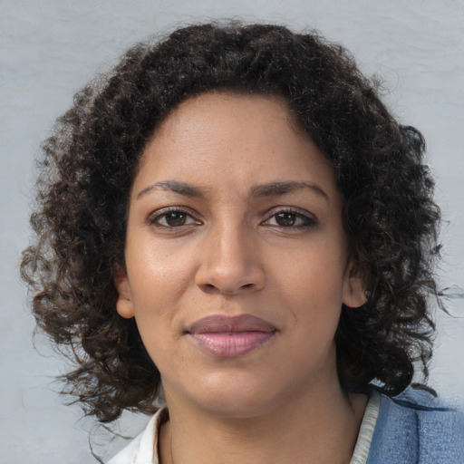 Joyful black young-adult female with medium  brown hair and brown eyes