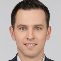 Joyful white young-adult male with short  brown hair and brown eyes