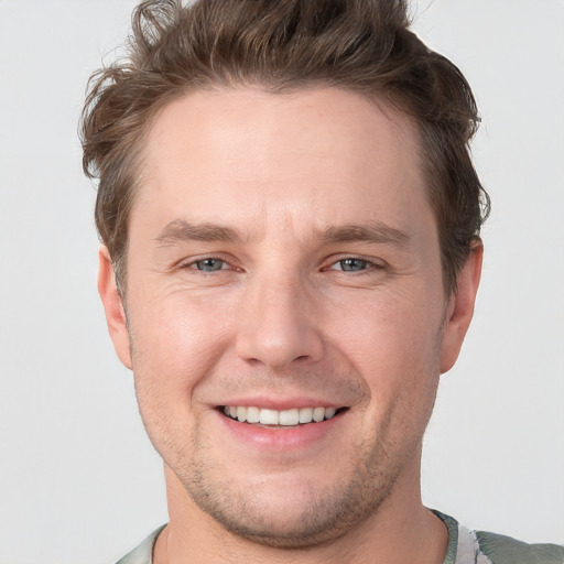 Joyful white adult male with short  brown hair and grey eyes