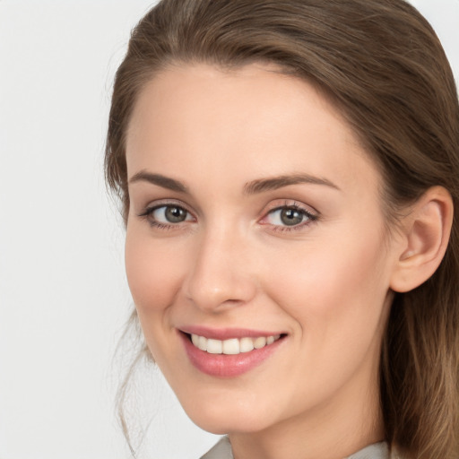 Joyful white young-adult female with long  brown hair and grey eyes