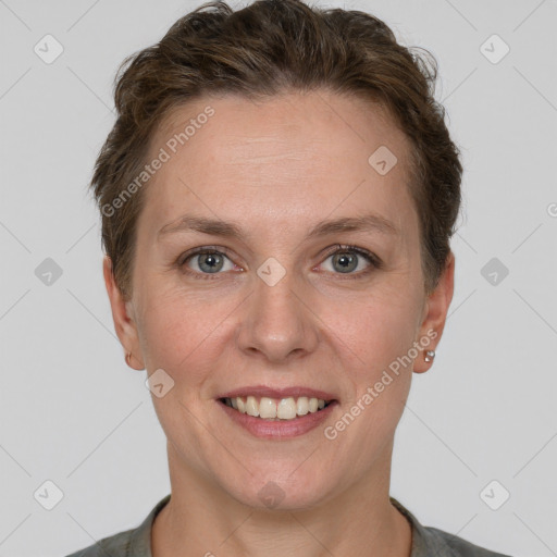 Joyful white adult female with short  brown hair and grey eyes