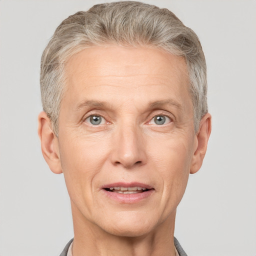 Joyful white middle-aged male with short  gray hair and grey eyes