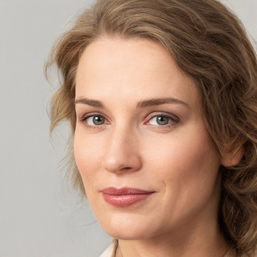 Joyful white young-adult female with medium  brown hair and green eyes