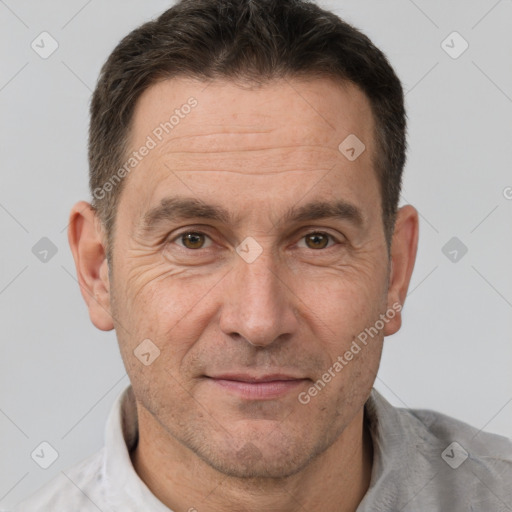 Joyful white adult male with short  brown hair and brown eyes