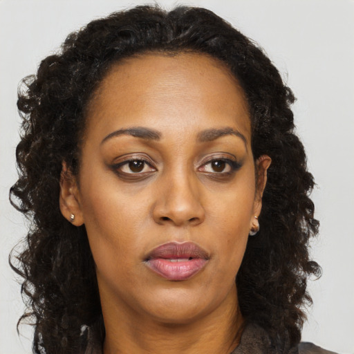 Neutral black adult female with long  brown hair and brown eyes