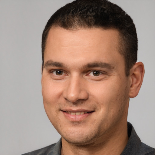 Joyful white adult male with short  brown hair and brown eyes